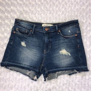 Lightly distressed mid rise denim shorts
